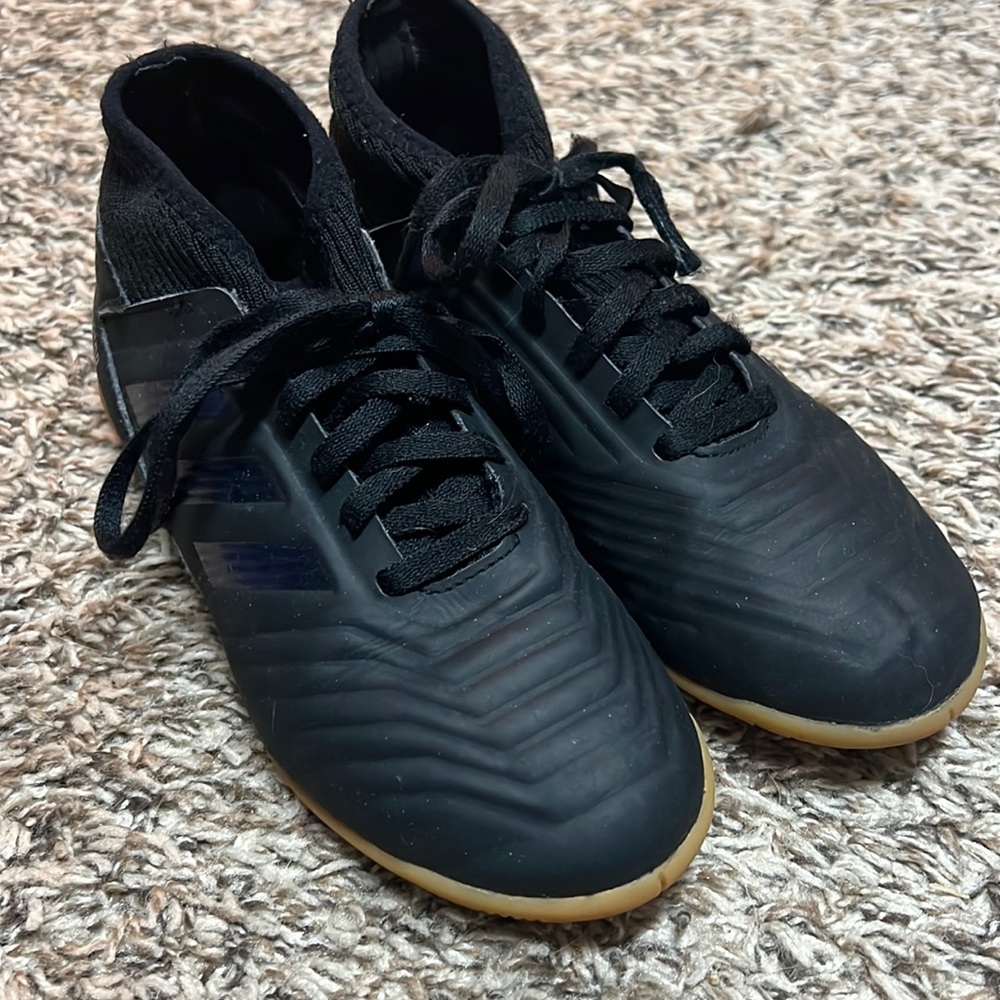 Kids Adidas Predator indoor soccer shoes.